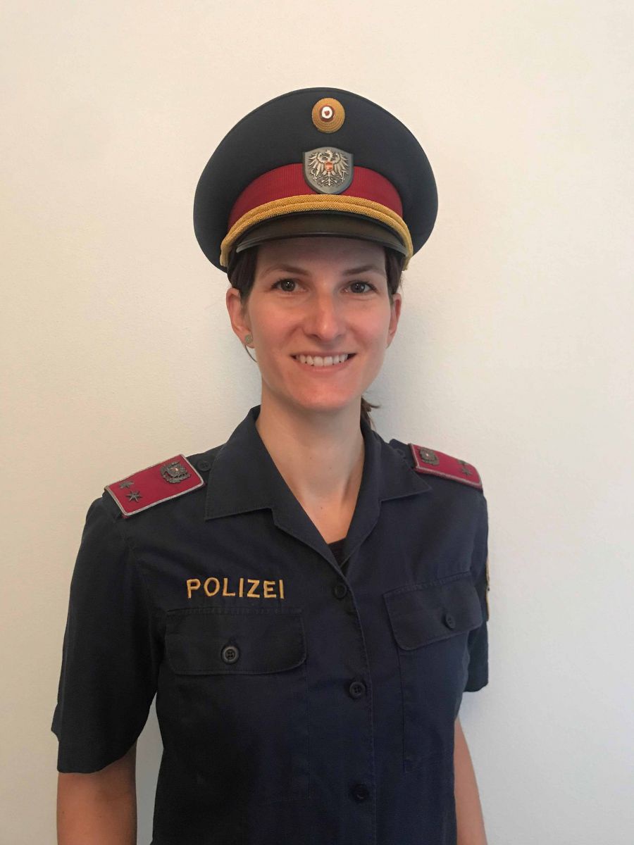 Eine junge Frau in österreichischer Polizeiuniform. Sie lächelt in die Kamera.